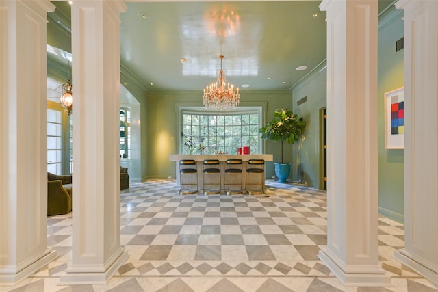 interior space with visible vents, a notable chandelier, ornamental molding, and ornate columns