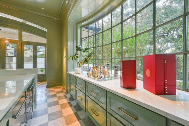 bar with light floors and ornamental molding