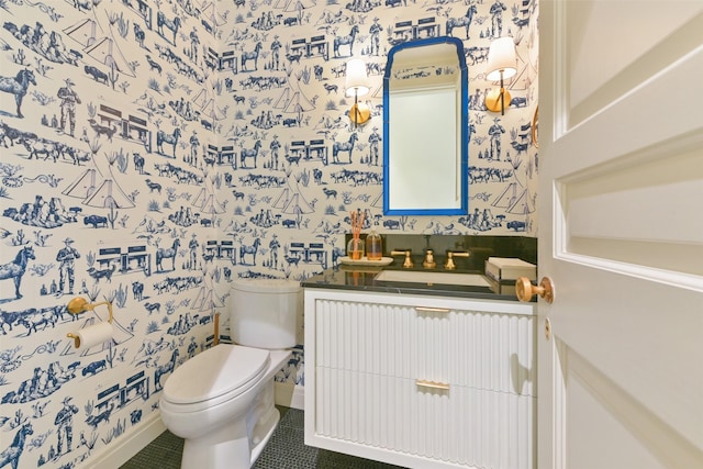 bathroom with wallpapered walls, baseboards, toilet, tile patterned floors, and vanity