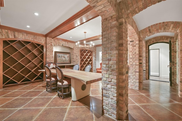 wine room featuring tile patterned floors, brick wall, and beam ceiling