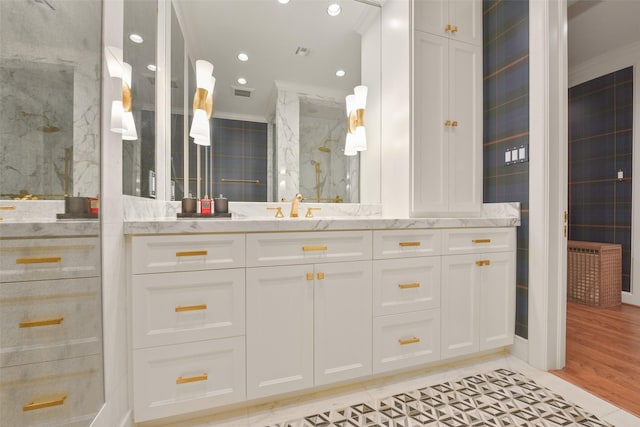 bathroom featuring tile patterned flooring, vanity, tile walls, and crown molding