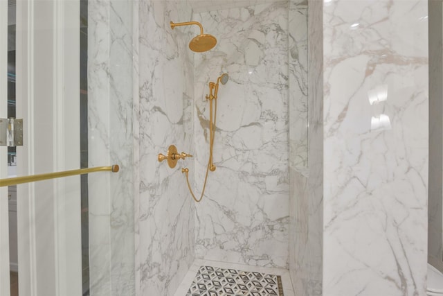 bathroom with a marble finish shower