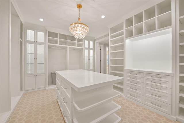 spacious closet featuring a notable chandelier