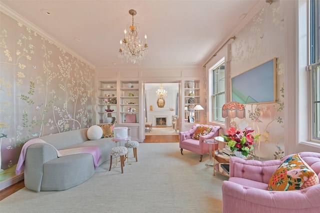 living room featuring built in shelves, wood finished floors, wallpapered walls, crown molding, and a chandelier