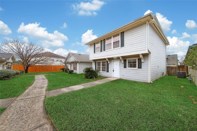 view of front of home with cooling unit and a front lawn