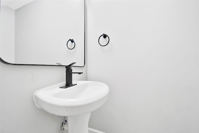 bathroom with vaulted ceiling and sink