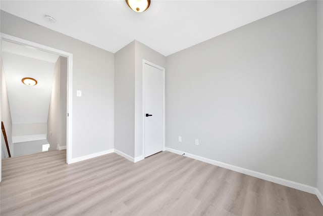 unfurnished bedroom with light wood-type flooring and a closet