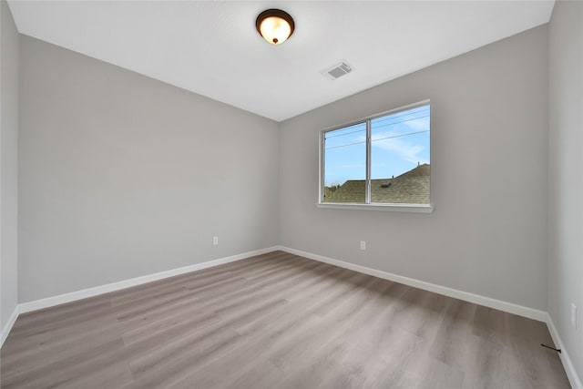 spare room featuring light hardwood / wood-style flooring