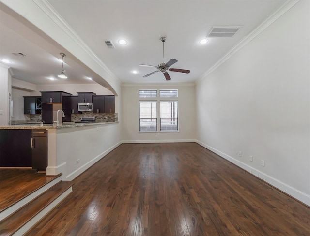 unfurnished living room with crown molding, sink, ceiling fan, and dark hardwood / wood-style flooring