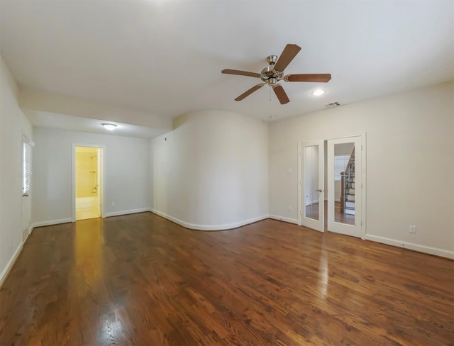 spare room with dark hardwood / wood-style floors and ceiling fan