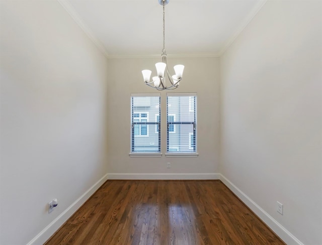 unfurnished room with crown molding, dark hardwood / wood-style floors, and a chandelier