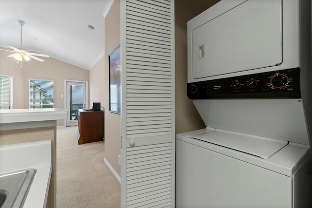 laundry area with stacked washing maching and dryer and ceiling fan