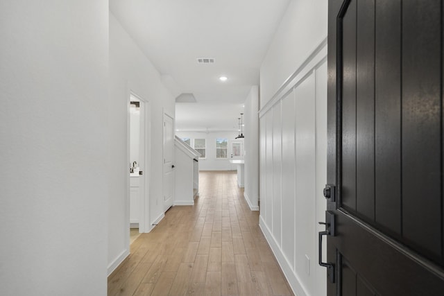 corridor with light hardwood / wood-style flooring