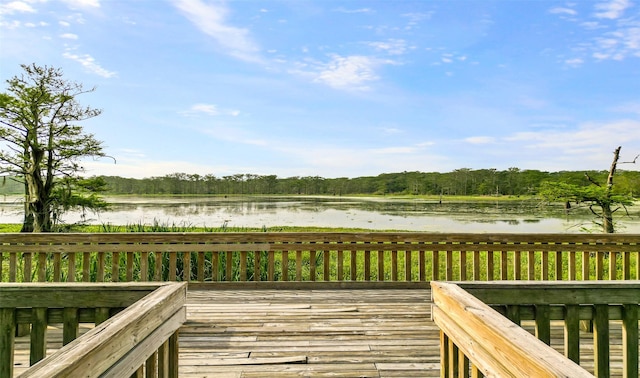 wooden terrace featuring a water view