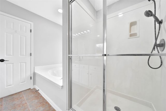 bathroom featuring separate shower and tub