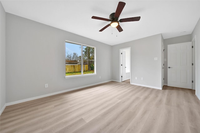 unfurnished bedroom featuring connected bathroom, light hardwood / wood-style flooring, and ceiling fan