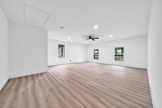 unfurnished room with ceiling fan, a wealth of natural light, and light hardwood / wood-style floors