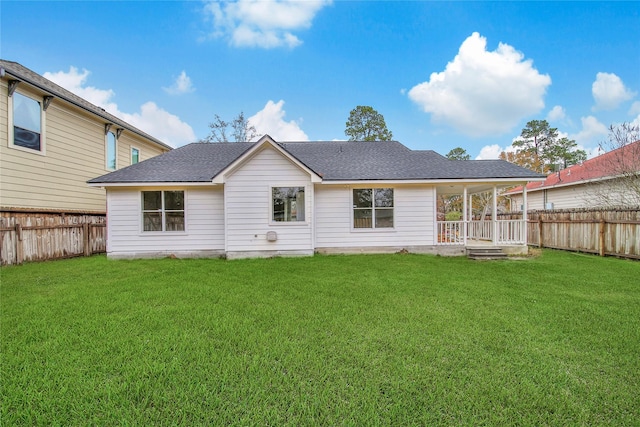 back of property featuring a lawn