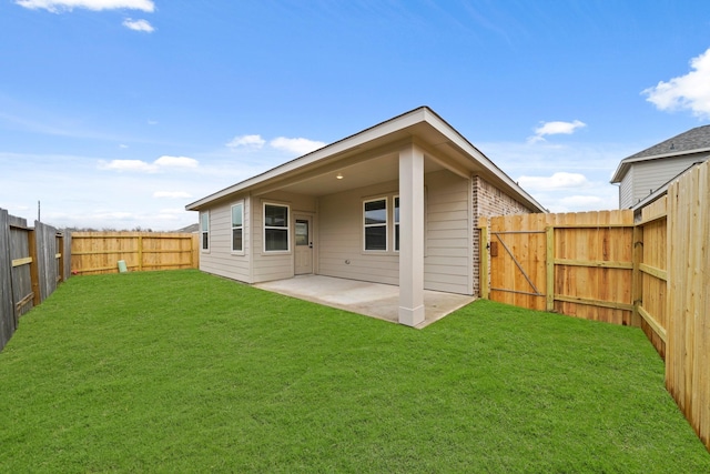 back of property with a patio and a lawn