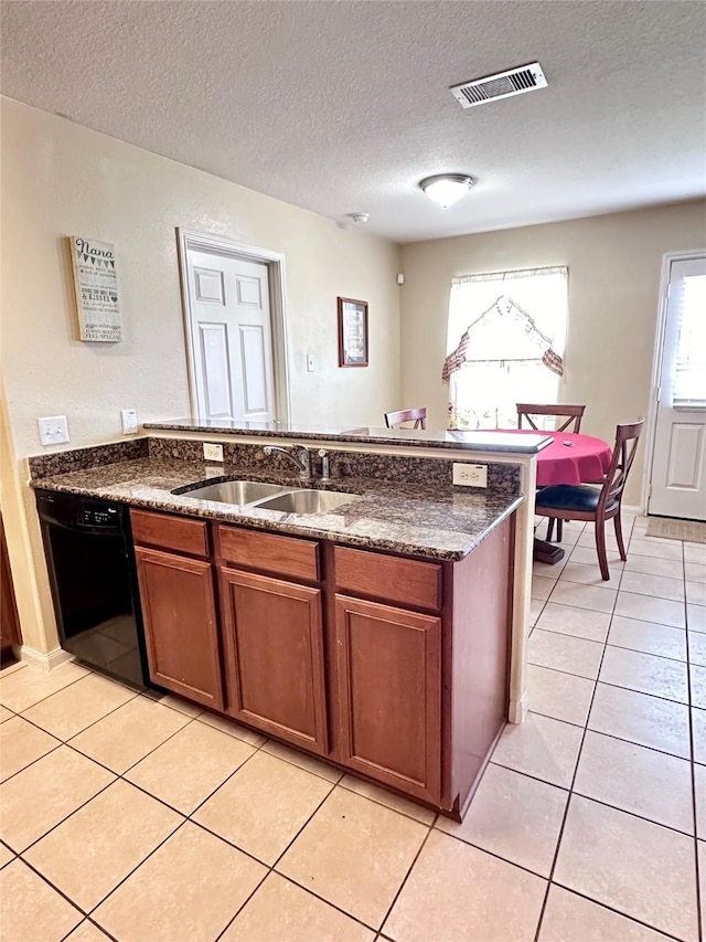 kitchen featuring light tile patterned flooring, black dishwasher, sink, dark stone countertops, and a textured ceiling