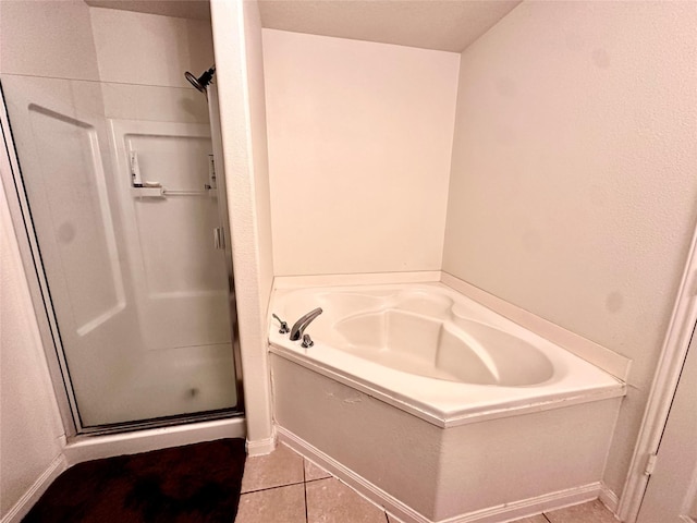 bathroom featuring tile patterned flooring and separate shower and tub