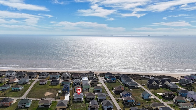 bird's eye view featuring a water view and a view of the beach