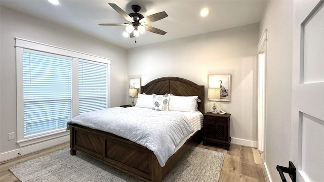 bedroom with ceiling fan and light hardwood / wood-style floors