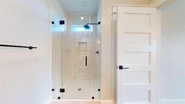 bathroom with a shower with shower door