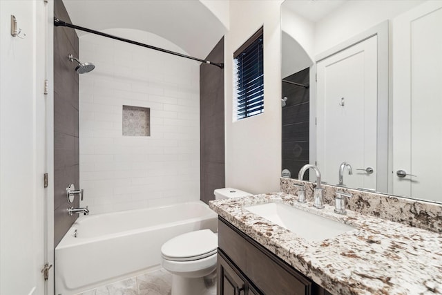 full bathroom featuring vanity, toilet, and tiled shower / bath combo