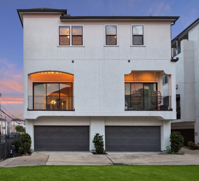 view of front facade featuring a garage and a balcony