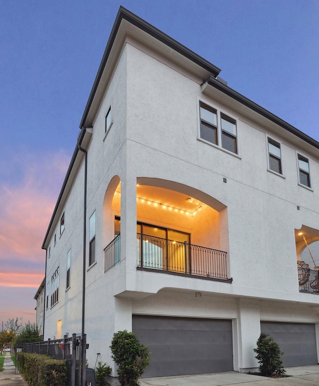 exterior space featuring a garage and a balcony