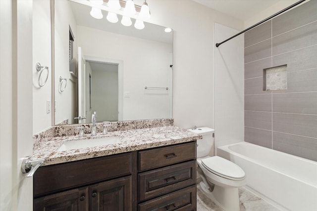 full bathroom with vanity, tiled shower / bath, and toilet