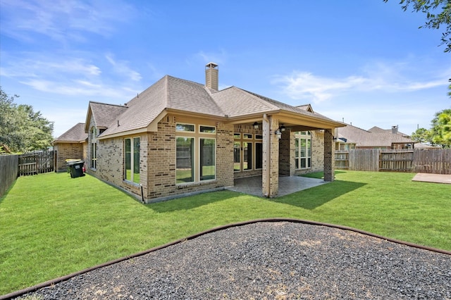 rear view of property featuring a patio area and a lawn