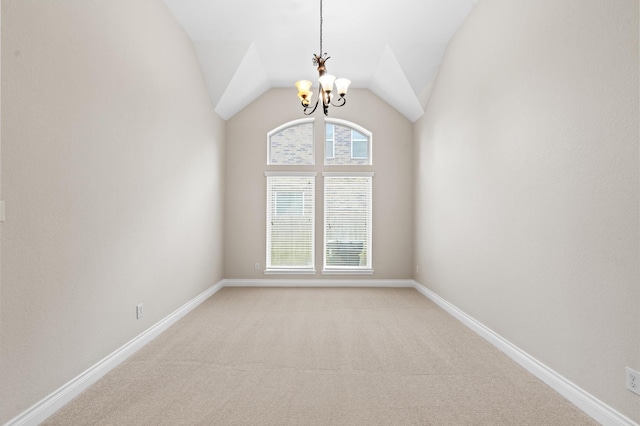 carpeted spare room featuring lofted ceiling and a notable chandelier