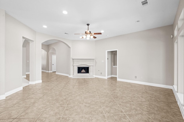 unfurnished living room with light tile patterned floors and ceiling fan