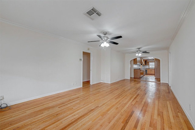 unfurnished living room featuring ornamental molding, ceiling fan, and light wood-type flooring