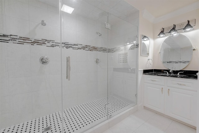 bathroom featuring ornamental molding, vanity, a shower with door, and tile patterned floors