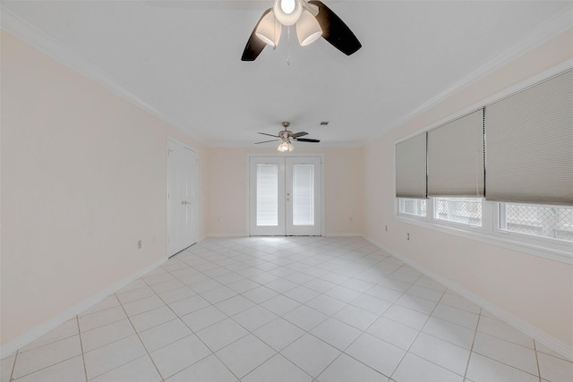 tiled spare room featuring crown molding, plenty of natural light, french doors, and ceiling fan