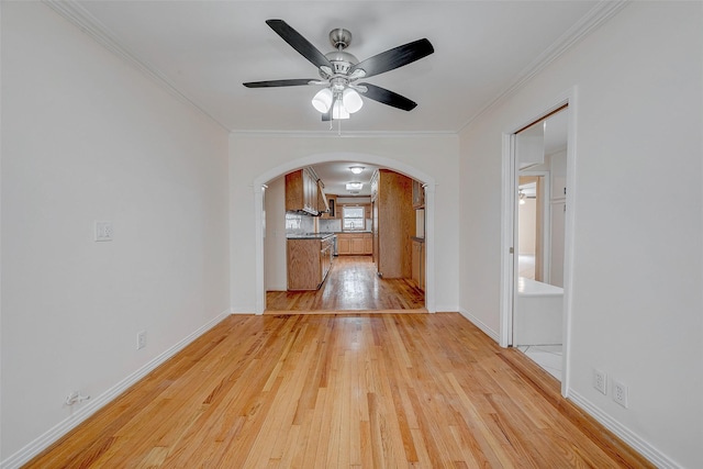 unfurnished living room with crown molding, ceiling fan, and light hardwood / wood-style floors