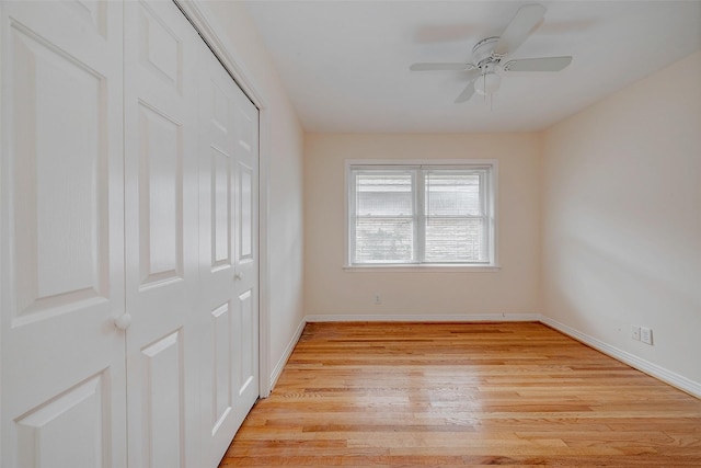 unfurnished bedroom featuring ceiling fan, a closet, and light hardwood / wood-style flooring