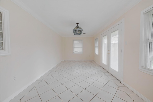 spare room with light tile patterned floors and crown molding