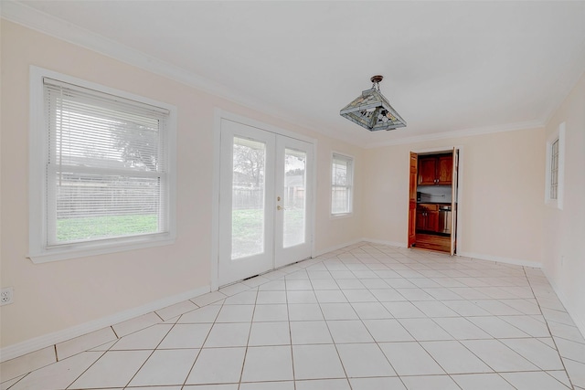 unfurnished room featuring light tile patterned floors, plenty of natural light, ornamental molding, and french doors