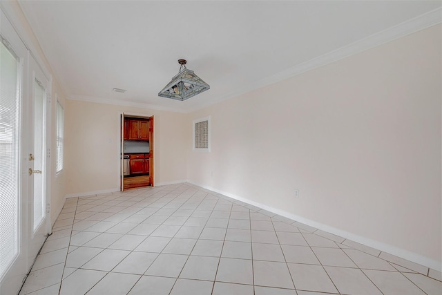 spare room featuring light tile patterned floors and ornamental molding