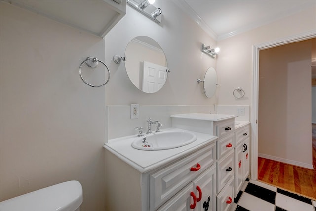 bathroom featuring vanity, ornamental molding, and toilet