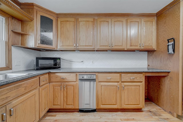 kitchen with light stone counters, decorative backsplash, and light wood-type flooring