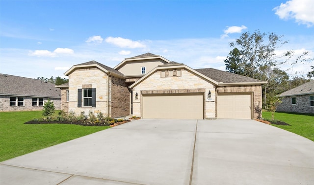 view of front of home with a garage and a front lawn