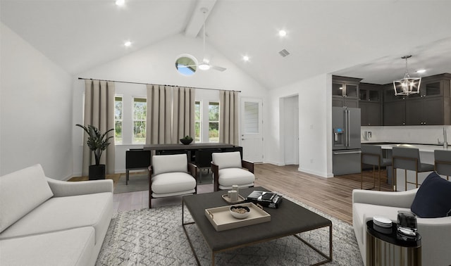 living room with beam ceiling, light hardwood / wood-style flooring, high vaulted ceiling, and ceiling fan