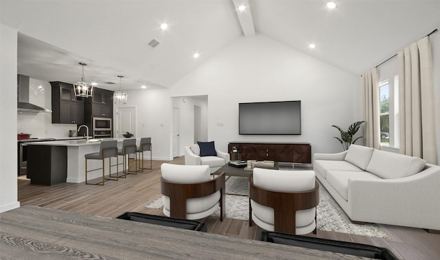 living room with beamed ceiling, sink, and high vaulted ceiling