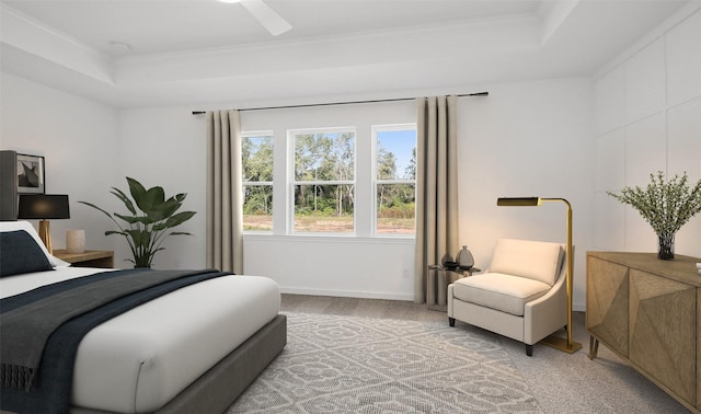 carpeted bedroom with ornamental molding, a raised ceiling, and ceiling fan