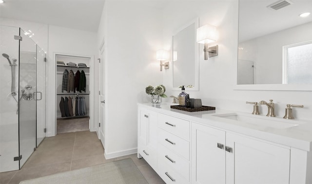 bathroom featuring vanity and a shower with shower door